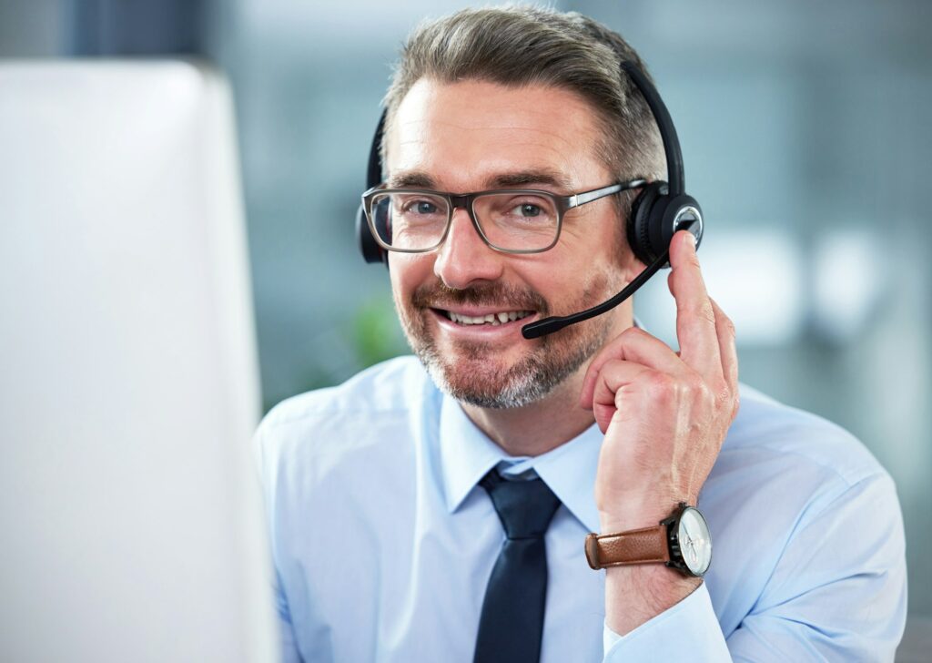 The friendliest call center agent. Shot of a mature male call center agent working in an office.